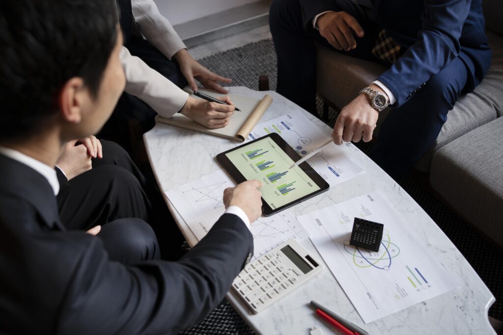 business-people-working-with-ipad-high-angle-min-scaled